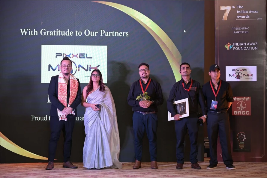 a group photo of the pixxelmonk team at an award event